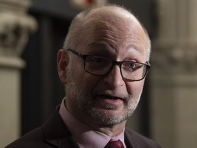 Minister of Justice and Attorney General of Canada David Lametti speaks with the media following a cabinet meeting on Parliament Hill in Ottawa, Feb. 25, 2020.