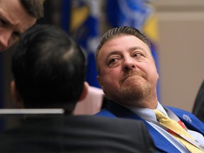 Calgary councillor Joe Magliocca talks with councillors Jeromy Farkas and Sean Chu during a council meeting on Monday, February 24, 2020. Council earlier approved a motion to launch a forensic audit of Magliocca's expenses.