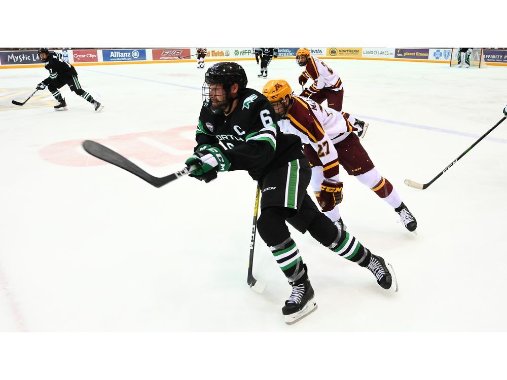 Teammates congratulate North Dakota Fighting Hawks defenseman