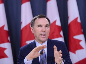 Minister of Finance Bill Morneau takes part in a press conference at the National Press Theatre in Ottawa on Friday, March 13, 2020.