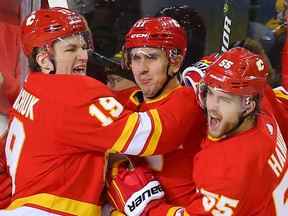 Calgary Flames Mikael Backlund celebrates with teammates after scoring a goal against the Boston Bruins during NHL hockey in Calgary on Friday February 21, 2020. Al Charest / Postmedia