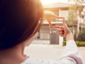 Hands of woman making frame gesture with home background. Planning for the future resident concept.