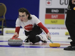 SAIT Trojans skip Andrew Manson throws a rock during Day 2 of the CCAA Curling National Championships.