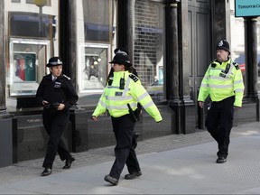 Cressida Dick (left), Commissioner of the Metropolitan Police Service, walks past a closed Tiffany store as she takes part in a police patrol on New Bond Street on March 24, 2020 in London. (Dan Kitwood/Getty Images)