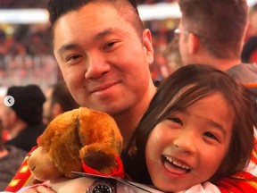 Raymond Lau with his daughter Emma at a recent Flames game. Lau started the fundraiser to help offset the impact of the COVID-19 pandemic for part-time Saddledome employees. Instagram