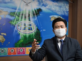 This photo taken on March 1, 2020 shows Kim Shin-chang, director of international missions at the Shincheonji Church of Jesus, wearing a face mask as he speaks during an interview with AFP at the headquarters of the church in Gwacheon, south of Seoul.