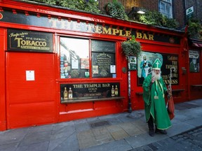 A man dressed up as Saint Patrick is pictured outside The Temple Bar pub, as bars across Ireland close voluntarily to curb the spread of coronavirus, in Dublin, Ireland, Sunday, March 15, 2020.