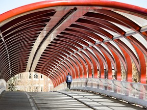 A lone pedestrian takes a walk on an empty Peace Bridge on Thursday, April 16, 2020.