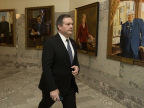 Premier Jason Kenney leaves his office and walks past portraits of former Alberta Premiers after delivering a televised address on the COVID-19 pandemic, at the Alberta Legislature in Edmonton Tuesday April 7, 2020. Photo by David Bloom