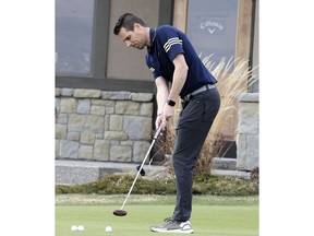 Slade King, COO of Blue Devil Golf Club, hits the putting green following Premier Jason Kenney's announcement to gradually open Alberta's economy. Golf courses in Alberta will be allowed to open this weekend, following strict physical distancing measures, during the COVID-19 pandemic. Thursday, April 30, 2020. Brendan Miller/Postmedia