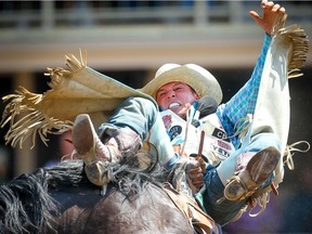 Texas, cowboy Richie Champion rides Added Money to a score of  82 points in Day 3 of the Calgary Stampede rodeo bareback event on  Sunday, July 7, 2019. Al Charest / Postmedia