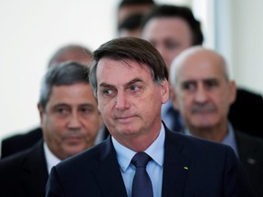 Brazil's President Jair Bolsonaro arrives at a press conference announcing economic measures, amid the coronavirus (COVID-19) outbreak, in Brasilia, April 1, 2020. (REUTERS/Ueslei Marcelino)