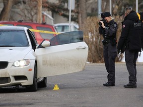 Police photograph a car at the scene of an early morning fatal shooting in in the 1600 block of 15th St. S.W. on Thursday, April 9, 2020