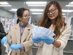 A group of volunteers prepare packages of masks, alcohol wipes and hand sanitzer on Saturday, February 8, 2020. Jim Wells/Postmedia