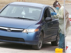 Dr Amelia Leskiw takes COVID-19 samples at a drive thru location in High River, AB, south of Calgary on Friday, April 17, 2020. There will be an larger off site up an running in the town on Monday. Jim Wells/Postmedia