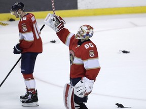 Florida Panthers goaltender Chris Driedger raises his stick after the Panthers defeated the Nashville Predators 3-0 in an NHL hockey game, Saturday, Nov. 30, 2019, in Sunrise, Fla. Photo by Lynne Sladky/AP.