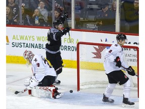 Calgary Hitmen Riley Fiddler-Schultz scores on Moose Jaw Warriors goalie Adam Evanoff in second-period WHL action at the Scotiabank Saddledome in Calgary on Sunday, Jan. 5. File photo by Darren Makowichuk/Postmedia.