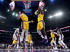 LeBron James of the Los Angeles Lakers grabs a rebound in front of Anthony Davis during a 104-102 loss to the Brooklyn Nets at Staples Center on March 10, 2020, in Los Angeles.