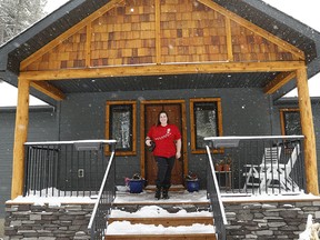 Emily Robertson poses for a "porchtrait" in Bragg Creek. She and her husband Brian have been taking porchtraits since the start of the COVID-19 pandemic.