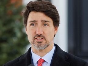 Prime Minister Justin Trudeau speaks to news media outside his home in Ottawa, March 25, 2020.