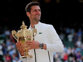 Novak Djokovic celebrates with the trophy as he celebrates winning the 2019 Wimbledon final against Switzerland's Roger Federer.