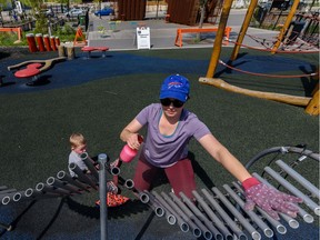 Schona Mrozek sanitizes the playground equipment for her two-year-old son Tyson to play in the playground in East Village on Friday, May 29, 2020.