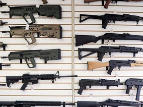 Semi-automatic rifles fill a wall at a gun shop in Lynnwood, Wash. The Canadian federal government has announced a ban on the use and sale of assault-style guns.