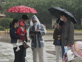 Tourists at Disney town as Disneyland imposes social distancing measures on May 5, 2020 in Shanghai, China.