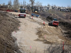 Crews continue to work on the Douglasdale and McKenzie Lake slope stability / pathway project on Tuesday May 5, 2020 a city report today said it will cost taxpayers $28 million.