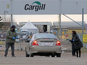 Union members handed out masks and information to workers entering the Cargill plant near High River while protesting the meat processing plant reopening on Monday, May 4, 2020. The plant had been temporarily shut down after hundreds of workers contracted COVID-19. The union says the plant is still not a safe for workers.