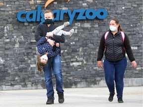 Parents, Matt and Tia Bell with daughter, Emerald,4, leave the Calgary Zoo as it opened in Calgary on Saturday, May 23, 2020.