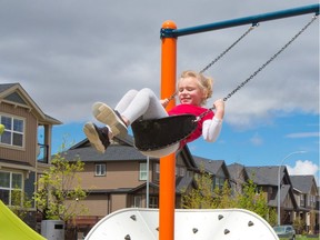 Cassidy Spragg enjoys the swings at the Midtown playground in Airdrie on Saturday, May 23, 2020. Airdrie opened playgrounds on Friday after they were closed for about two months because of the COVID-19 pandemic.