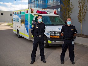 Calgary EMS paramedics Stuart Brideaux, left and Shane Paton were photographed for a story about how work for paramedics has changed during the COVID-19 pandemic on Wednesday, May 27, 2020.