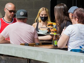 Lunch hour business was brisk at the Trolley 5 restaurant in Calgary on Monday, May 25, 2020. After about two months Calgarians can sit down again in restaurants with COVID-19 precautions.