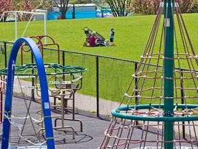 Kids play outside a closed Bridgeland playground on Thursday, May 28, 2020. Closed over 2 months ago due to the COVID-19 pandemic playgrounds are expected to open again on Monday, June 1.