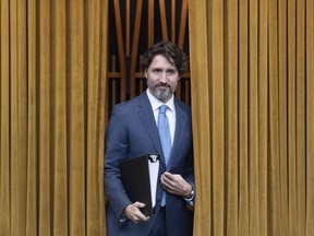 Prime Minister Justin Trudeau walks through the curtains before a session of the Special Committee on the COVID-19 Pandemic to begin in the Chamber of the House of Commons in Ottawa, Wednesday May 13, 2020.