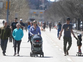Calgarians take to the blocked off portion of Memorial Drive near 5 St NW in northwest Calgary on Sunday, April 19, 2020.