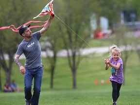 Justin Gaulin flies a kite with his daughter Riley 6 yrs in Stanley Park in Calgary on Sunday, May 31, 2020.