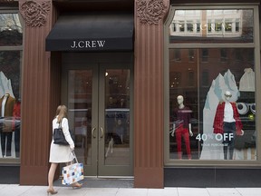 In this Dec. 21, 2016, file photo, a woman walks into a J. Crew clothing store in Washington, D.C.