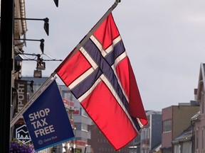 A Norwegian flag flutters over a shop in Tromso, Norway September 19, 2019.