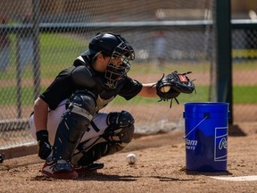 Okotoks Dawgs catcher Colin Yeomans participates in team practice at Seaman Stadium yesterday.  
Azin Ghaffari/Postmedia