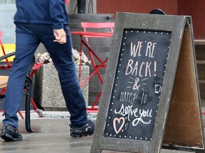 A sign in Kensington welcomes customers back to the Higher Ground coffee shop.