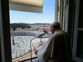This handout picture taken and released on Sunday, May 31, 2020, by Vatican Media shows Pope Francis leading the 'Regina Coeli' prayer from the window of the Apostolic Palace overlooking St. Peter's Square at the Vatican.