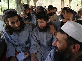 Taliban prisoners sit inside a vehicle during their release from the Bagram prison, next to the U.S. military base in Bagram, some 50 km north of Kabul.