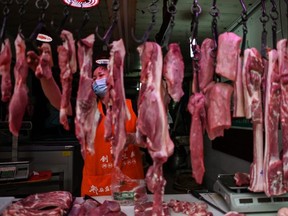 A vendor wearing a face mask works in her stall in a market in Wuhan, in Chinas central Hubei province on May 21, 2020.