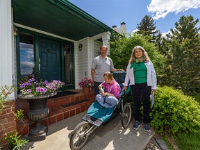 Margaret and Mark Anderson and their daughter Hannah pose for a photo outside their house in Woodbine on Thursday, June 4, 2020. Anderson's house is being crowded out by Southwest ring road construction.