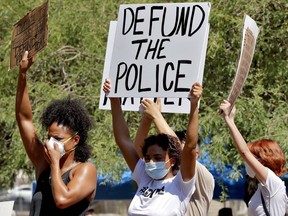 Protesters rally Wednesday, June 3, 2020, in Phoenix, demanding the Phoenix City Council defund the Phoenix Police Department. The protest is a result of the death of George Floyd, a black man who died after being restrained by Minneapolis police officers on May 25. (AP Photo/Matt York)