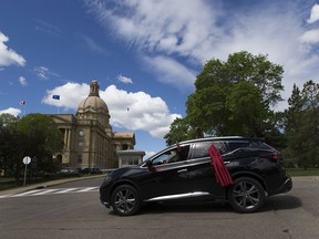 Betty Letendre drives past the legislature as she takes part in the Convoy 4 Action on Wednesday, June 3, 2020 in Edmonton. The convoy marks the one-year anniversary of a report that offered more than 200 recommendations relating to murdered and missing Indigenous women and girls in Canada.