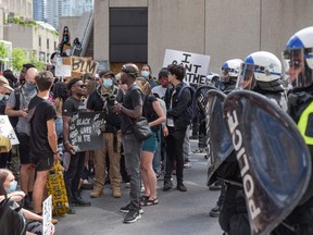 Montreal Police and protesters face off during a march against police brutality and racism in Montreal on June 7 2020.