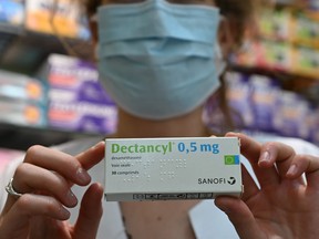 A picture taken on June 16, 2020 in Paris shows a box of Dectancyl, a drug manufactured by Sanofi containing dexamethasone.